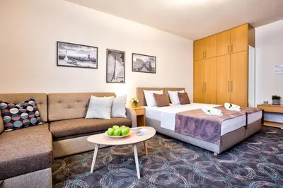 a hotel room with a bed and a couch at Booking Apartments in Belgrade