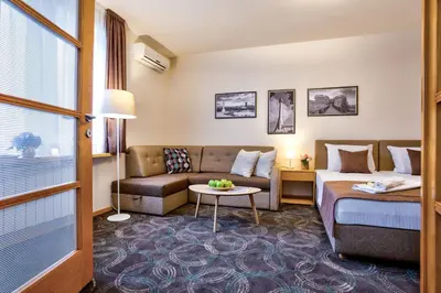 a hotel room with a bed and a couch at Booking Apartments in Belgrade