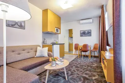 a living room with a couch and a table at Booking Apartments in Belgrade