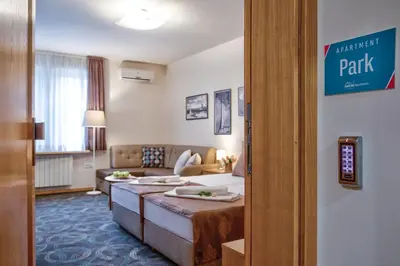 a hotel room with a bed and a couch at Booking Apartments in Belgrade