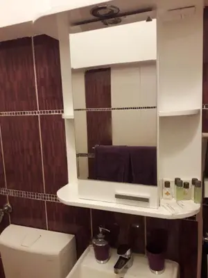 a bathroom with a mirror above a toilet at Apartment Ema in Belgrade