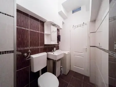 a small bathroom with a toilet and a sink at Apartment Ema in Belgrade