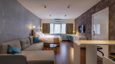 a hotel room with a bed and a living room at Level Luxury Suites in Belgrade