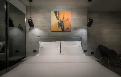 a bedroom with a large white bed with two pillows at Level Luxury Suites in Belgrade