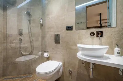 a bathroom with a shower and a toilet and a sink at Level Luxury Suites in Belgrade