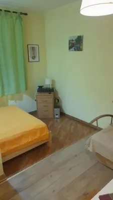 a bedroom with two beds and a dresser in it at Vracar Krunska Jamiva in Belgrade