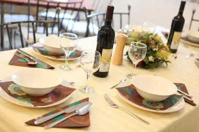 a table with plates and glasses and wine bottles at The Belgrade Hills Rooms and Suites in Belgrade