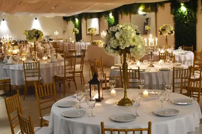 a banquet hall with tables with white flowers and candles at The Belgrade Hills Rooms and Suites in Belgrade