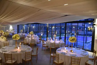 a large room with tables and chairs with candles at The Belgrade Hills Rooms and Suites in Belgrade