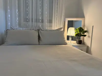 a bedroom with a white bed with a window at Barbara in Belgrade