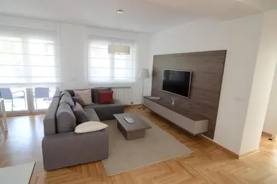 a living room with a couch and a flat screen tv at Apartman Nodilova in Belgrade