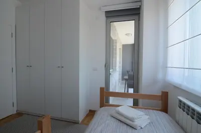 a bedroom with a bed with two towels on it at Apartman Nodilova in Belgrade