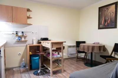 a small kitchen with a desk and a table at House of Vracar in Belgrade