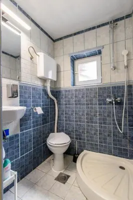 a bathroom with a toilet and a sink and a shower at House of Vracar in Belgrade