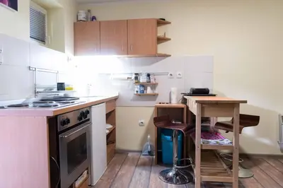 a small kitchen with a table and a stove at House of Vracar in Belgrade