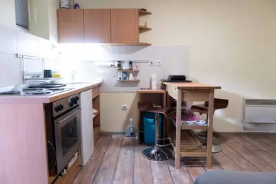 a small kitchen with a table and a stove at House of Vracar in Belgrade
