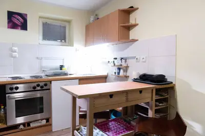 a small kitchen with a wooden table in it at House of Vracar in Belgrade
