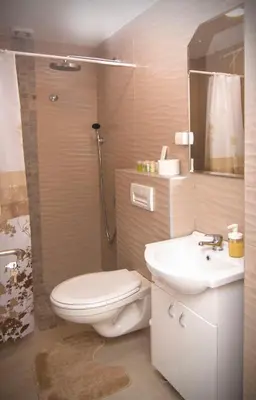 a bathroom with a toilet and a sink and a shower at Beo Green View in Belgrade