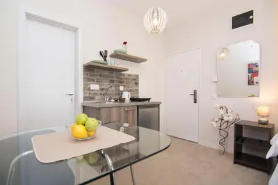 a kitchen with a table with a bowl of fruit on it at Beo Green View in Belgrade