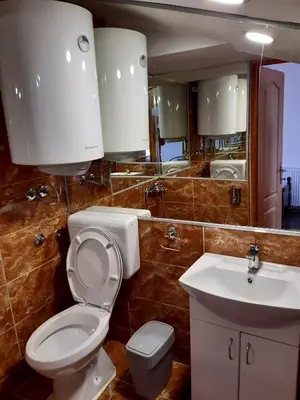 a bathroom with a toilet and a sink and a mirror at Hedonist in Stara Pazova