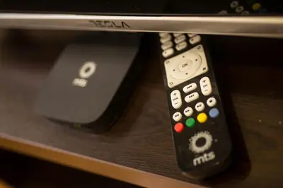 two remote controls sitting on top of a table at Free.three in Belgrade