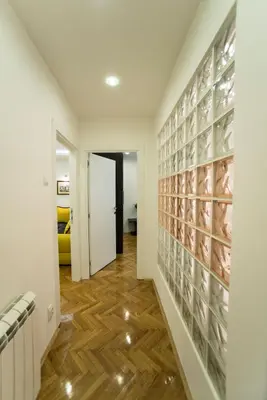 a hallway with a wall of wine bottles at Free.three in Belgrade
