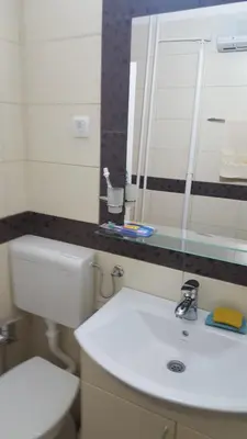 a bathroom with a white sink and a mirror at Apartman Jogi in Vračar (historical)