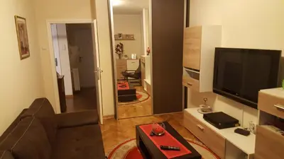 a living room with a couch and a flat screen tv at Apartman Jogi in Vračar (historical)