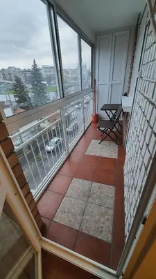a room with a balcony with a view of the city at Apartman Jogi in Vračar (historical)