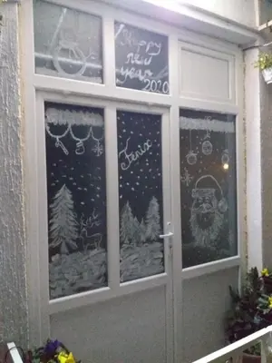 a front door with christmas decorations on it at Apartman Fenix in Belgrade