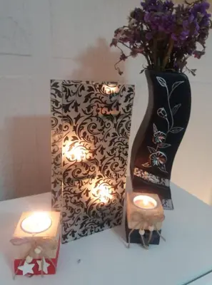 a table with two candles and a vase with flowers at Apartman Fenix in Belgrade