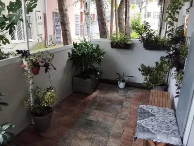 a courtyard with potted plants and a bench in a room at Apartman Fenix in Belgrade