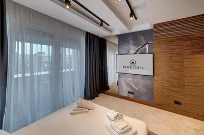 a hotel room with a bed and a sign that reads black trail at Black Pearl Luxury Suites in Belgrade
