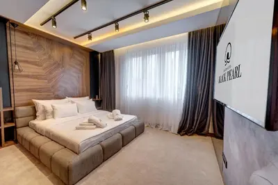 a hotel room with a bed with towels on it at Black Pearl Luxury Suites in Belgrade