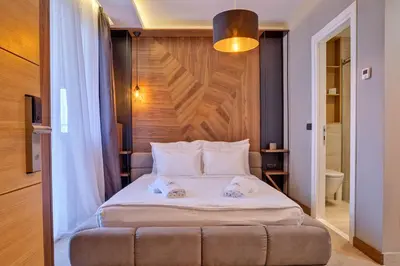 a bedroom with a bed with two towels on it at Black Pearl Luxury Suites in Belgrade