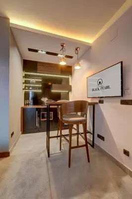 a dining room with a table and a chair at Black Pearl Luxury Suites in Belgrade