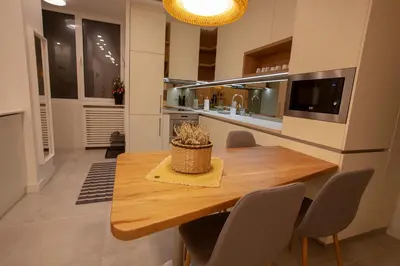 a kitchen with a wooden table and some chairs at BestStay Apartment No 9 Pedestrian zone in Belgrade