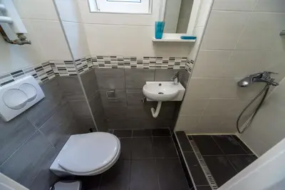 a bathroom with a toilet and a sink at Ikar Apartments in Belgrade