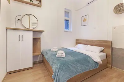 a bedroom with a bed with two towels on it at Ikar Apartments in Belgrade