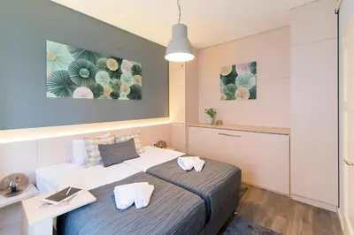 a small bedroom with a bed and a desk at Top Central 5 Apartments in Belgrade