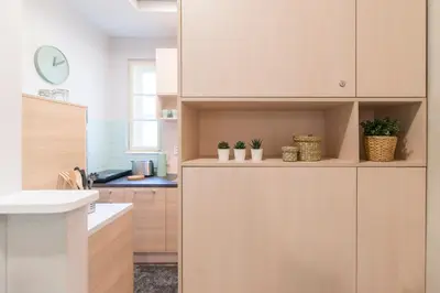 a kitchen with wooden cabinets with plants in it at Top Central 5 Apartments in Belgrade