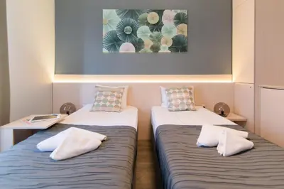 two beds with pillows sitting next to each other in a room at Top Central 5 Apartments in Belgrade