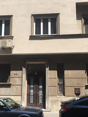 a black car parked in front of a building with a door at Top Central 5 Apartments in Belgrade