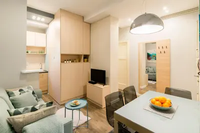 a kitchen and a living room with a table and a couch at Top Central 5 Apartments in Belgrade