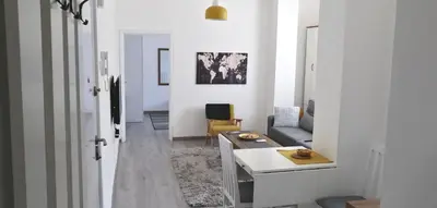 a white living room with a couch and a table at Jumi in Belgrade