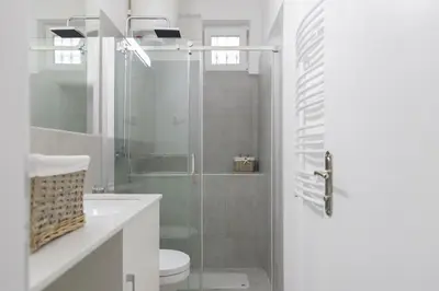 a bathroom with a shower and a toilet and a glass door at Jumi in Belgrade