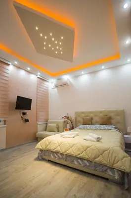 a bedroom with a bed and a flat screen tv at Lupino Apartments in Belgrade