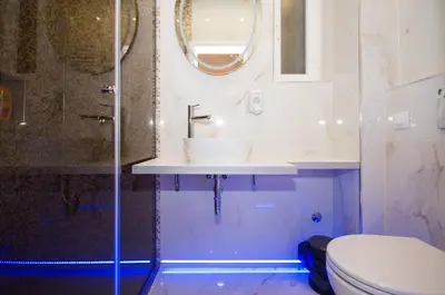 a bathroom with a sink and a toilet and a mirror at Lupino Apartments in Belgrade
