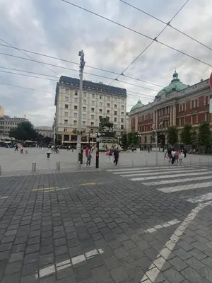 a city square with people walking around and buildings at Lupino Apartments in Belgrade