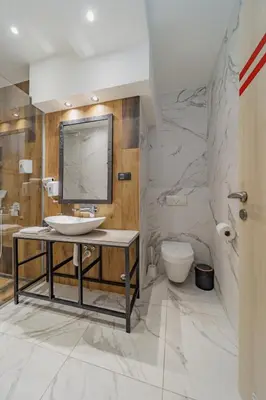 a bathroom with a sink and a toilet at Hotel Garni VIZURA Sport in Belgrade